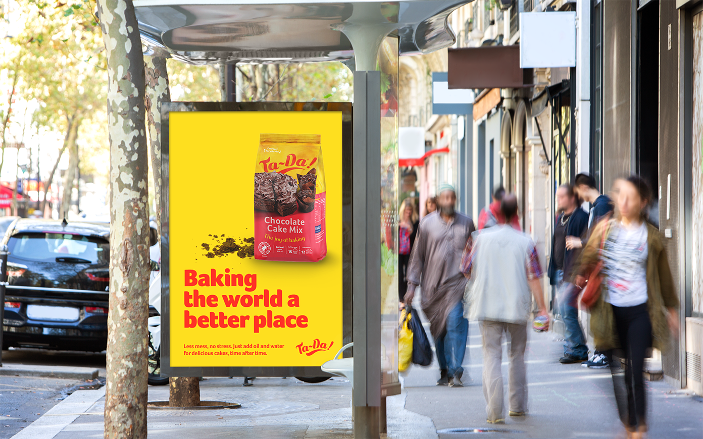 A bus stop advert with Ta-Da!'s chocolate cake mix and the headline "Baking the world a better place". Designed by Mighty, advertising agency