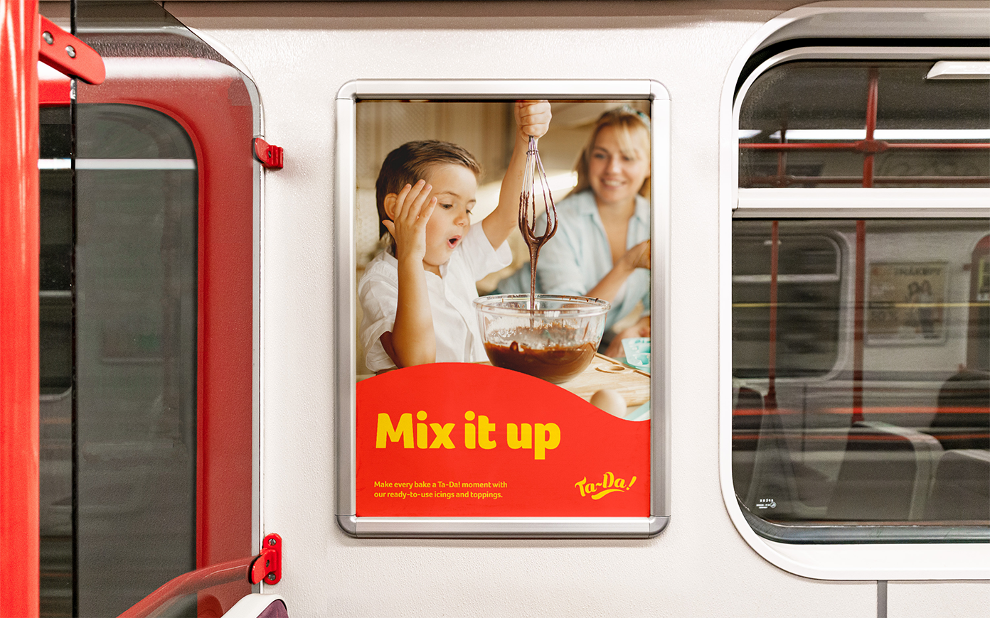 A train poster for Ta-Da that includes a young boy mixing cake and the headline"Mix it up", designed as part of a brand campaign by Mighty, brand agency